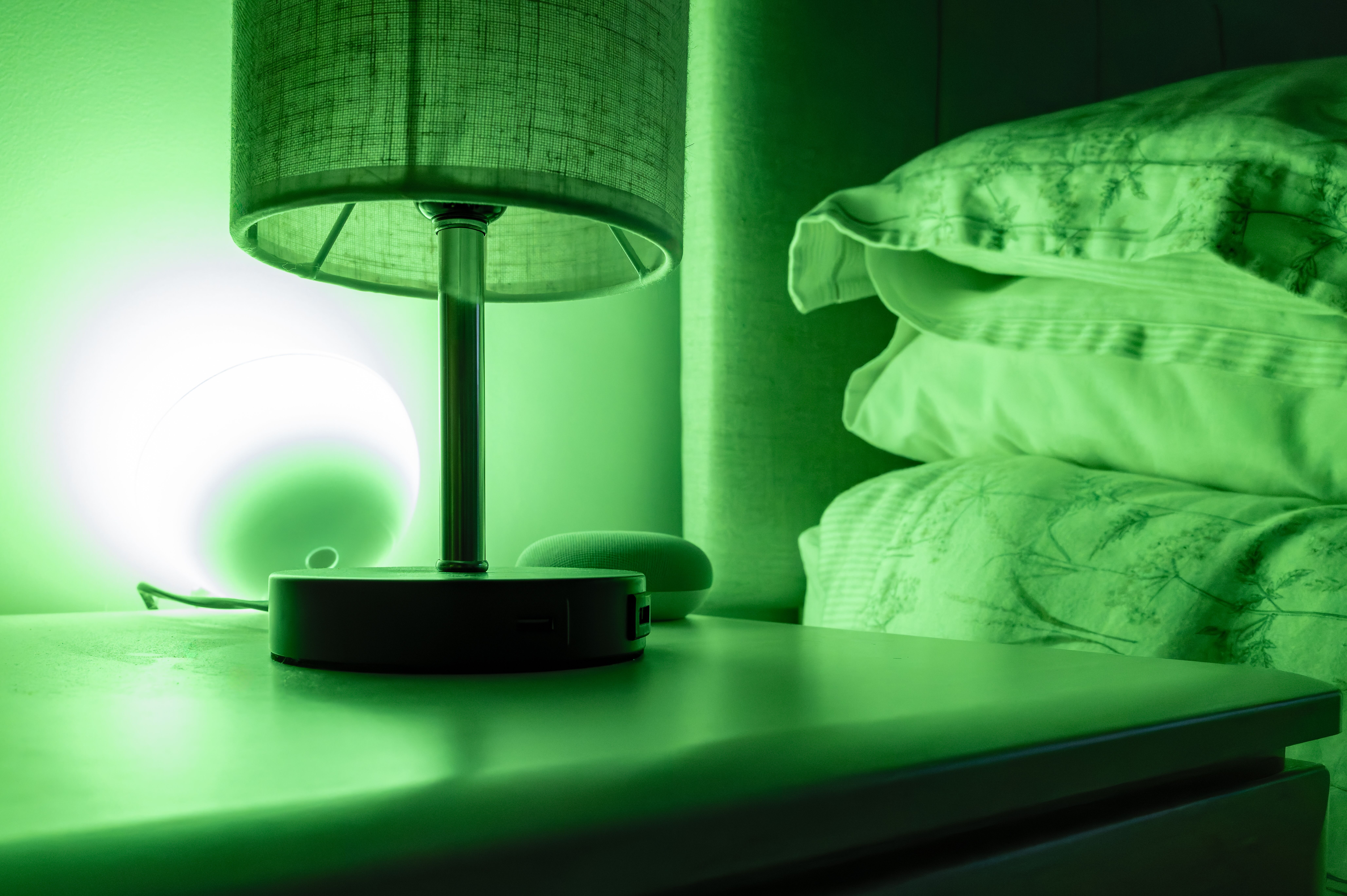 A bedroom with green LED lights, making it a calming room.