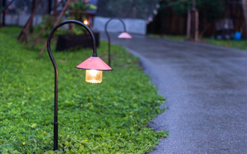 A beautiful walkway lit by lights - service provided by Custom Electrical Services .